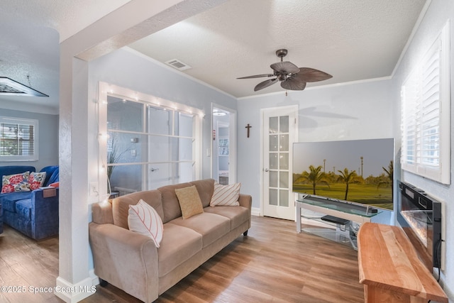 1029 Palmer Rd, Rockledge, FL 32955 - living room with a textured ceiling, wood finished floors, ceiling fan, and ornamental molding