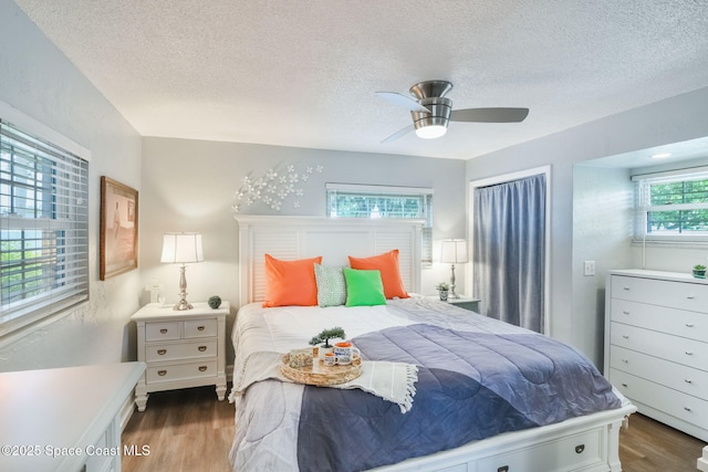 1029 Palmer Rd, Rockledge, FL 32955 - bedroom with wood finished floors, a textured ceiling, and a ceiling fan