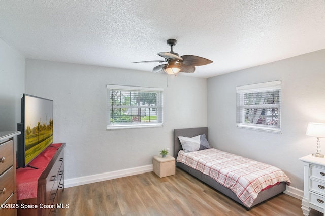 1029 Palmer Rd, Rockledge, FL 32955 - bedroom featuring wood finished floors, a textured ceiling, and ceiling fan