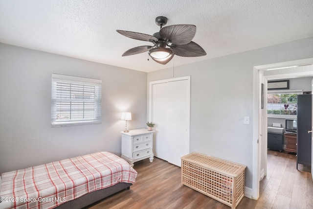 1029 Palmer Rd, Rockledge, FL 32955 - bedroom featuring wood finished floors, a closet, a textured ceiling, and a ceiling fan