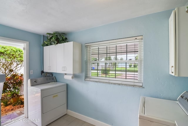 1029 Palmer Rd, Rockledge, FL 32955 - laundry area with cabinet space, washer and dryer, and light wood-style floors