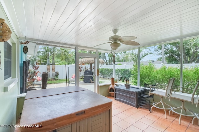 1029 Palmer Rd, Rockledge, FL 32955 - sunroom with tile patterned flooring, a hot tub, a ceiling fan, and plenty of natural light