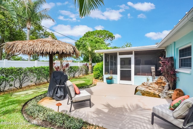 1029 Palmer Rd, Rockledge, FL 32955 - fenced backyard with a sunroom, a wooden deck, a putting green, and grilling area