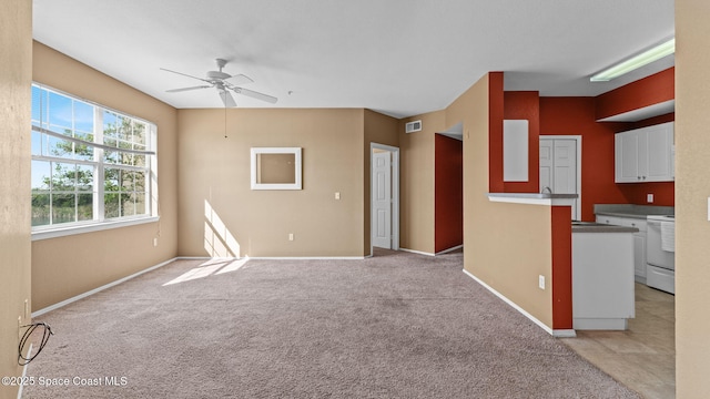 1766 Sophias Dr Unit 204, Melbourne, FL 32940 - unfurnished living room featuring a ceiling fan, baseboards, and light colored carpet