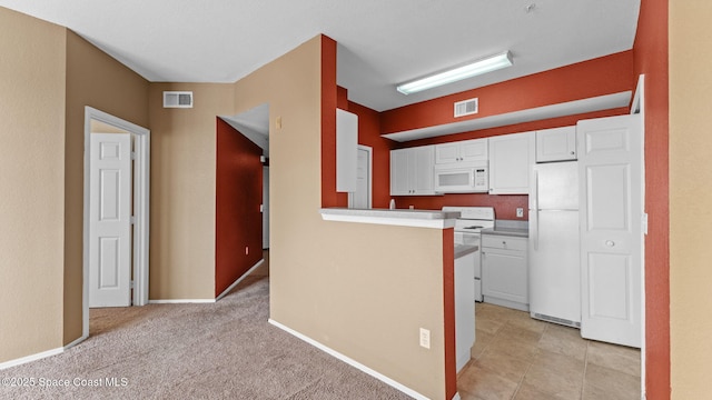 1766 Sophias Dr Unit 204, Melbourne, FL 32940 - kitchen featuring white appliances, white cabinetry, light countertops, and a peninsula