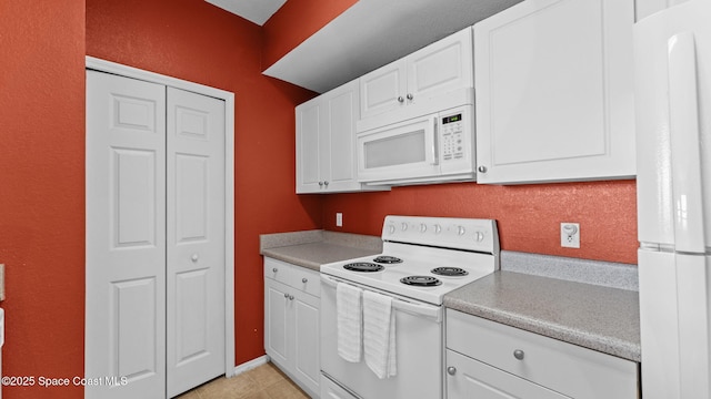 1766 Sophias Dr Unit 204, Melbourne, FL 32940 - kitchen with white appliances, light countertops, white cabinets, and light tile patterned floors
