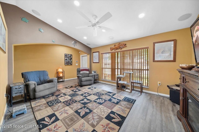 1160 Waco Blvd SE, Palm Bay, FL 32909 - living area featuring wood finished floors, arched walkways, lofted ceiling, ceiling fan, and baseboards