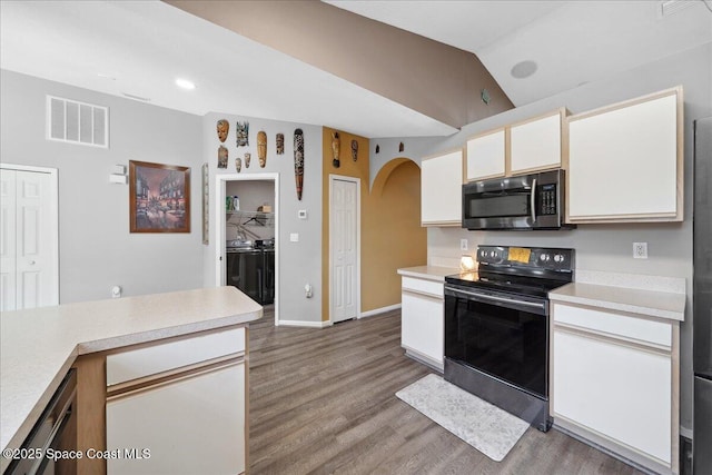 1160 Waco Blvd SE, Palm Bay, FL 32909 - kitchen featuring electric range, stainless steel microwave, washer and clothes dryer, arched walkways, and light countertops