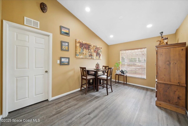 1160 Waco Blvd SE, Palm Bay, FL 32909 - dining area featuring baseboards, wood finished floors, lofted ceiling, and recessed lighting