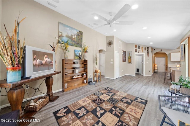 1160 Waco Blvd SE, Palm Bay, FL 32909 - living room featuring arched walkways, a ceiling fan, recessed lighting, wood finished floors, and baseboards
