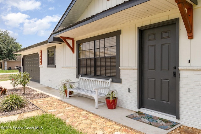 5460 Holden Rd, Cocoa, FL 32927 - entrance to property with board and batten siding, brick siding, an attached garage, and a porch