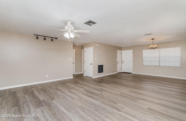 5460 Holden Rd, Cocoa, FL 32927 - unfurnished living room with ceiling fan, track lighting, a chandelier, and baseboards