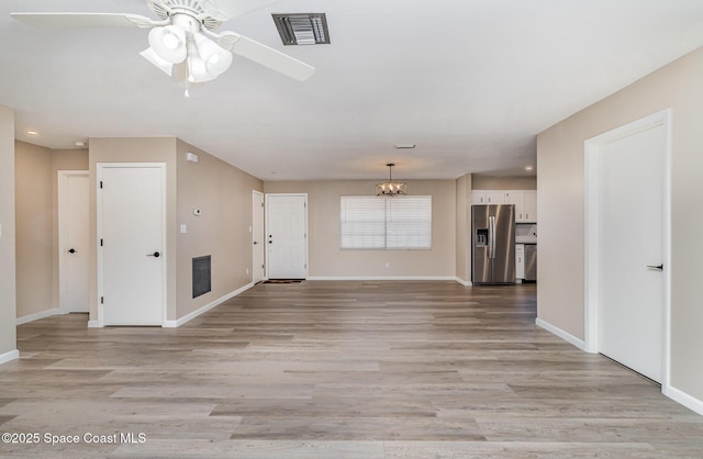 5460 Holden Rd, Cocoa, FL 32927 - unfurnished living room featuring baseboards, light wood-type flooring, ceiling fan, recessed lighting, and a chandelier