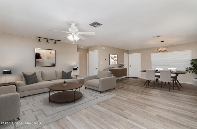 5460 Holden Rd, Cocoa, FL 32927 - living room with rail lighting, a chandelier, light wood-type flooring, ceiling fan, and baseboards