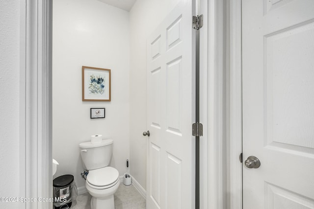 1717 Dalroy St NW, Palm Bay, FL 32907 - bathroom with baseboards, toilet, and tile patterned flooring