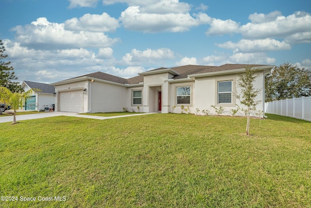 1717 Dalroy St NW, Palm Bay, FL 32907 - view of front of property featuring driveway, stucco siding, and an attached garage