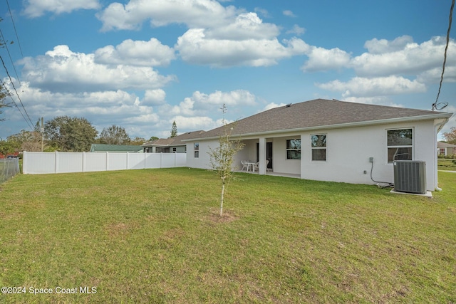 1717 Dalroy St NW, Palm Bay, FL 32907 - back of house featuring stucco siding, central AC unit, and roof with shingles