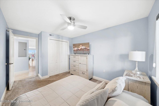 121 Lancha Cir Unit 206, Indian Harbour Beach, FL 32937 - bedroom with baseboards, light colored carpet, electric panel, and a closet