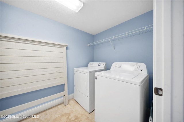 121 Lancha Cir Unit 206, Indian Harbour Beach, FL 32937 - laundry area featuring separate washer and dryer and baseboards
