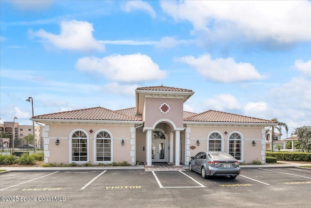 121 Lancha Cir Unit 206, Indian Harbour Beach, FL 32937 - view of building exterior featuring uncovered parking