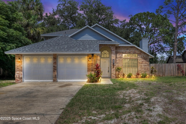 6827 Dodge Rd, Cocoa, FL 32927 - view of front facade with a garage, a shingled roof, concrete driveway, brick siding, and a chimney