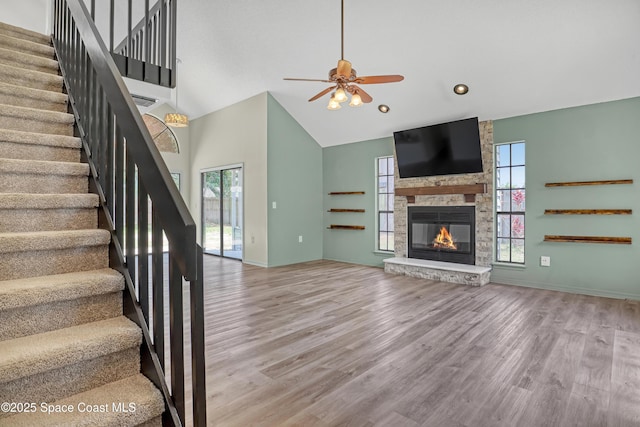 6827 Dodge Rd, Cocoa, FL 32927 - unfurnished living room with high vaulted ceiling, a ceiling fan, stairway, wood finished floors, and healthy amount of natural light