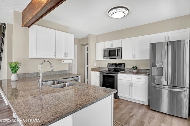 6827 Dodge Rd, Cocoa, FL 32927 - kitchen with appliances with stainless steel finishes, a sink, a peninsula, light stone counters, and light wood finished floors