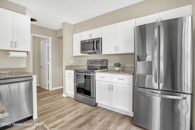 6827 Dodge Rd, Cocoa, FL 32927 - kitchen featuring stainless steel appliances, white cabinets, and light wood-style floors