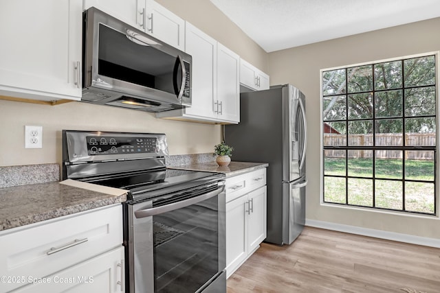 6827 Dodge Rd, Cocoa, FL 32927 - kitchen with appliances with stainless steel finishes, healthy amount of natural light, and white cabinets