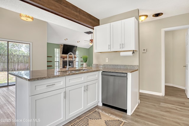 6827 Dodge Rd, Cocoa, FL 32927 - kitchen featuring dishwasher, a sink, a fireplace, ceiling fan, and a peninsula