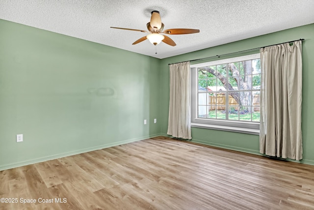 6827 Dodge Rd, Cocoa, FL 32927 - spare room with ceiling fan, a textured ceiling, wood finished floors, and baseboards