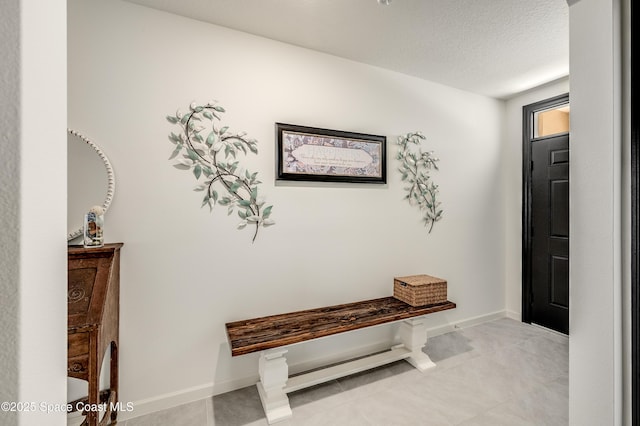 1460 Glendale Ave NW, Palm Bay, FL 32907 - entryway featuring a textured ceiling, baseboards, and light tile patterned floors