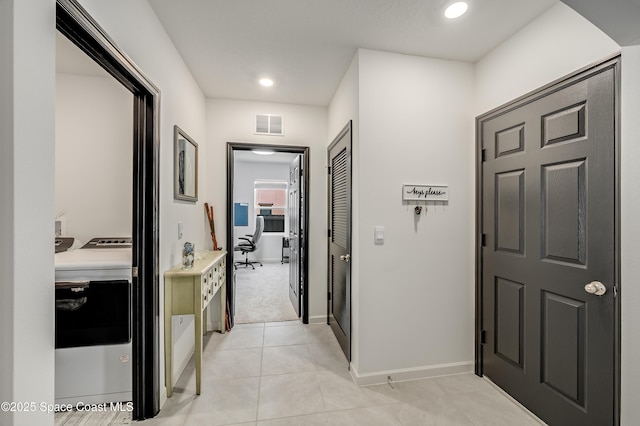 1460 Glendale Ave NW, Palm Bay, FL 32907 - corridor featuring washer and dryer, recessed lighting, baseboards, and light tile patterned floors