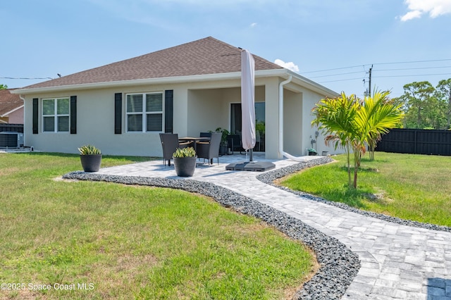 1460 Glendale Ave NW, Palm Bay, FL 32907 - back of property featuring central air condition unit, a patio, and stucco siding