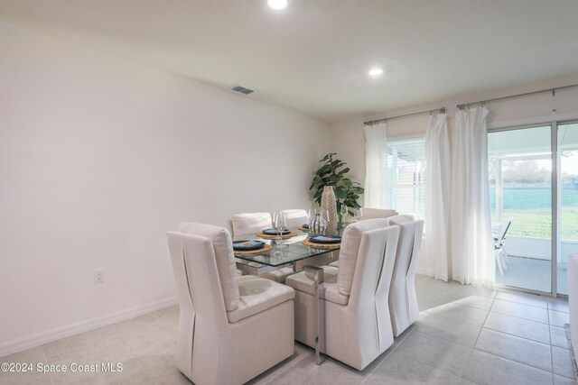 817 Redrock St SE, Palm Bay, FL 32909 - dining space featuring recessed lighting, healthy amount of natural light, light tile patterned flooring, and baseboards
