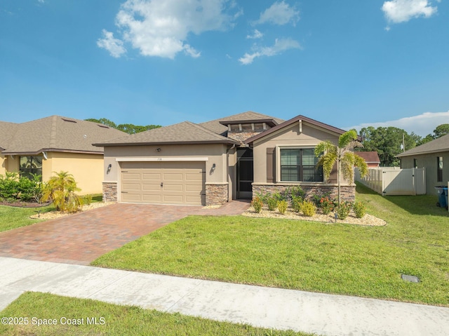 738 Old Country SE, Palm Bay, FL 32909 - view of front of property featuring stucco siding, stone siding, decorative driveway, and an attached garage