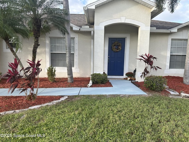 2259 Cogan Dr, Palm Bay, FL 32909 - entrance to property with stucco siding and a shingled roof