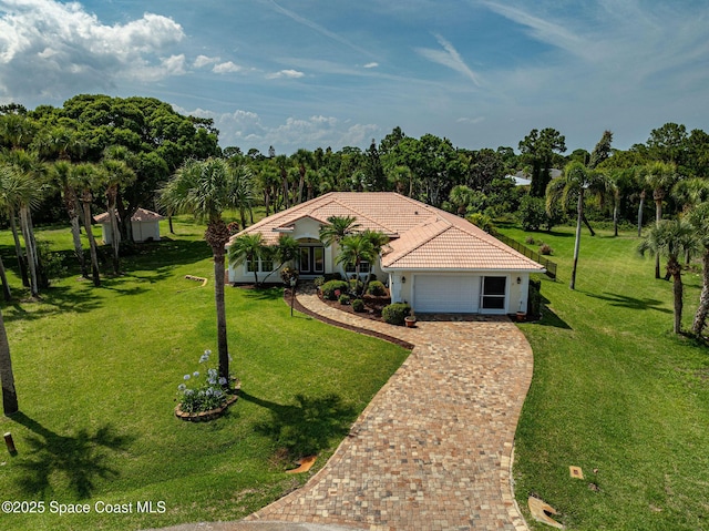 208 Chello Ave, Sebastian, FL 32958 - view of front of property with an attached garage, decorative driveway, a tiled roof, and a front lawn
