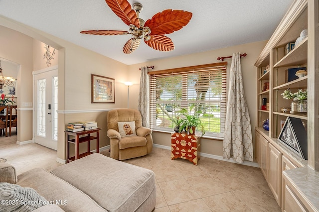 208 Chello Ave, Sebastian, FL 32958 - living room featuring healthy amount of natural light, light tile patterned floors, baseboards, ceiling fan, and a textured ceiling