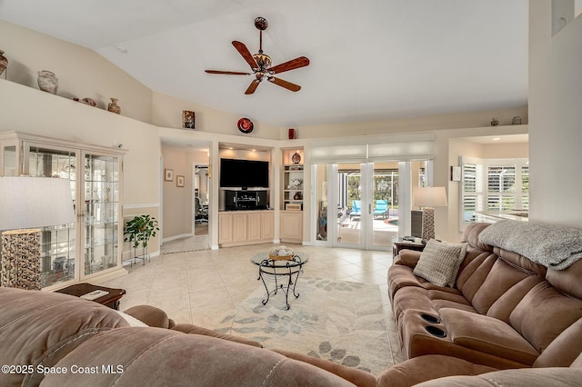 208 Chello Ave, Sebastian, FL 32958 - living area featuring light tile patterned floors, vaulted ceiling, a ceiling fan, french doors, and built in shelves