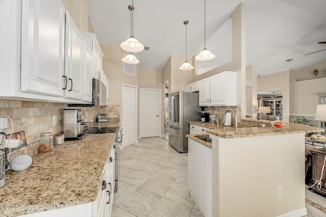 208 Chello Ave, Sebastian, FL 32958 - kitchen with appliances with stainless steel finishes, a sink, backsplash, light stone counters, and a peninsula