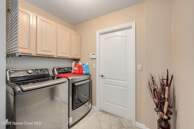 208 Chello Ave, Sebastian, FL 32958 - laundry area featuring washer and clothes dryer, cabinet space, baseboards, light tile patterned floors, and a textured ceiling