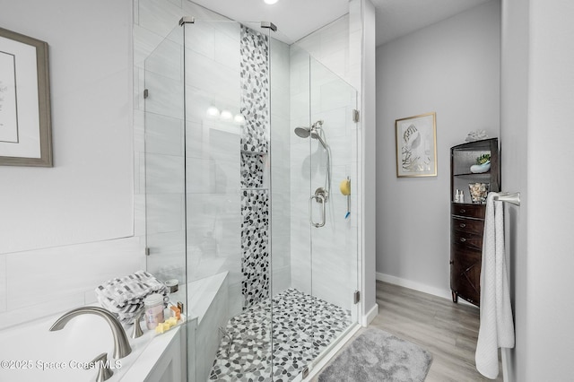 208 Chello Ave, Sebastian, FL 32958 - full bathroom with a shower stall, a garden tub, wood finished floors, and baseboards