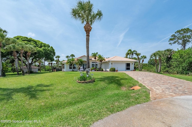 208 Chello Ave, Sebastian, FL 32958 - ranch-style house with an attached garage, driveway, and a front yard