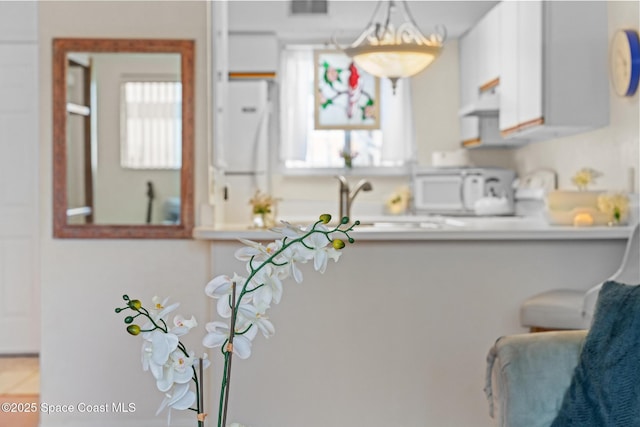 217 Ocean Park Ln Unit V49, Cape Canaveral, FL 32920 - kitchen with white appliances, light countertops, white cabinets, and extractor fan