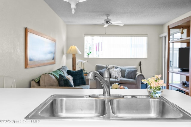 217 Ocean Park Ln Unit V49, Cape Canaveral, FL 32920 - kitchen featuring a sink, a ceiling fan, light countertops, a textured ceiling, and open floor plan