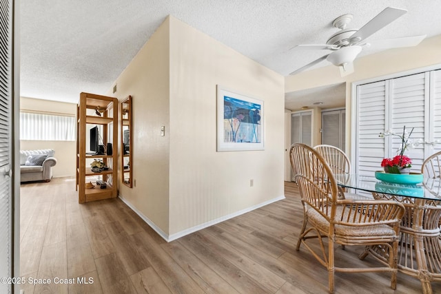 217 Ocean Park Ln Unit V49, Cape Canaveral, FL 32920 - dining room with a textured ceiling, ceiling fan, wood finished floors, and baseboards