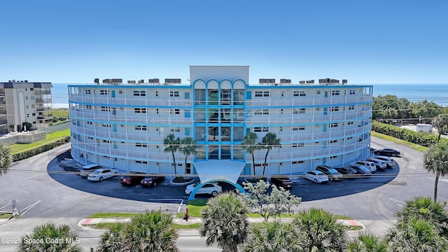 4000 Ocean Beach Blvd Unit 1J, Cocoa Beach, FL 32931 - view of apartment building / complex featuring uncovered parking and a water view
