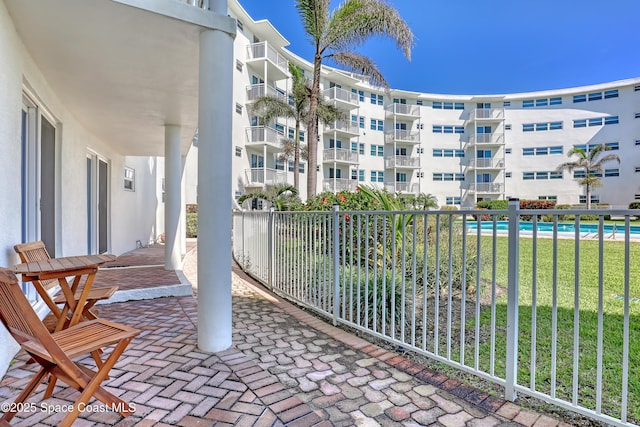 4000 Ocean Beach Blvd Unit 1J, Cocoa Beach, FL 32931 - view of patio with a community pool and a balcony