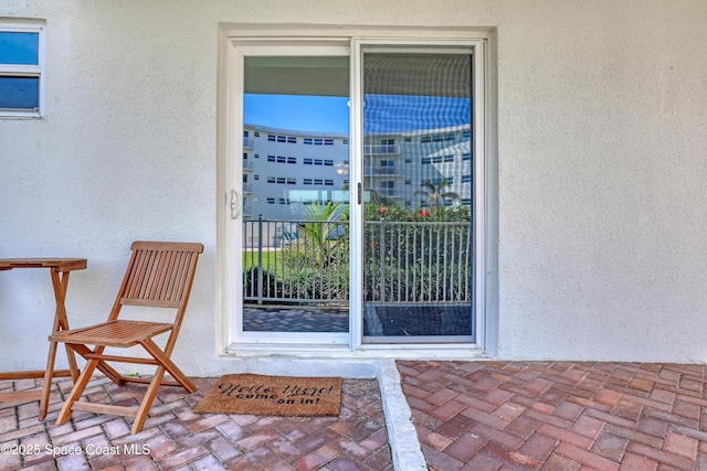 4000 Ocean Beach Blvd Unit 1J, Cocoa Beach, FL 32931 - doorway to property featuring stucco siding and a balcony